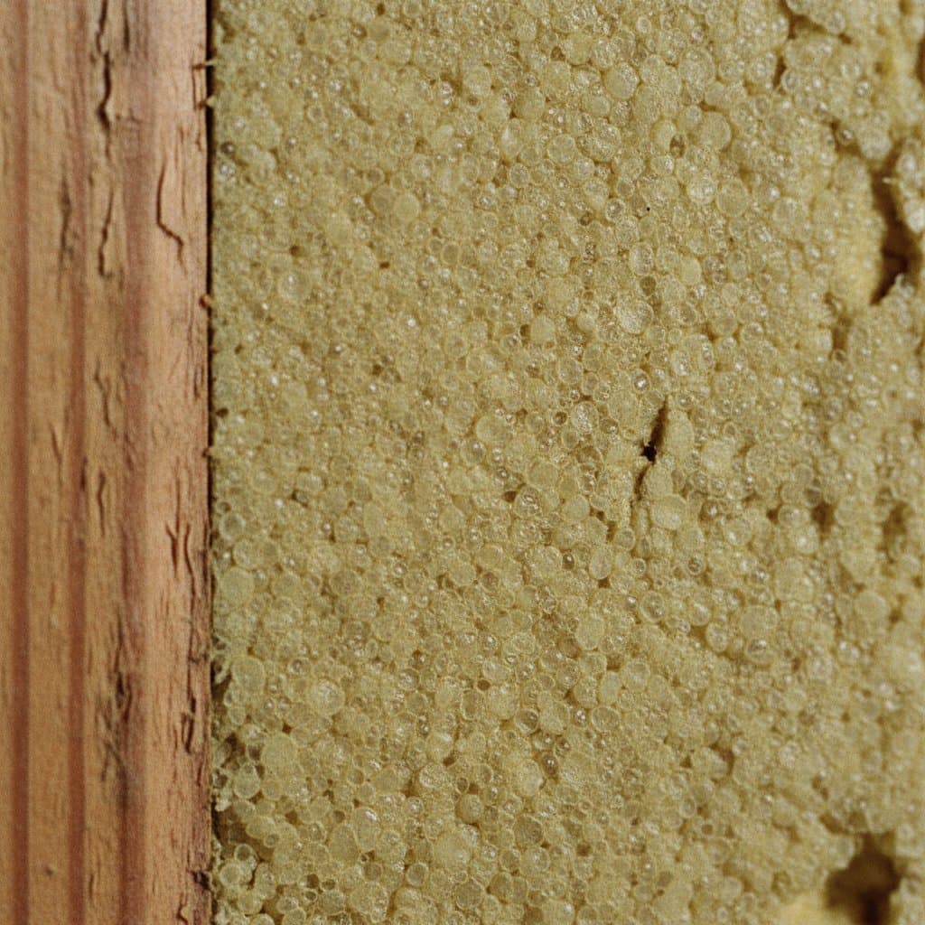 Close-up of cured closed-cell spray foam at stud edge